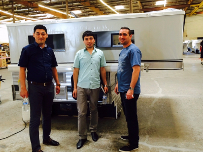 Three visitors at a family-owned “pop-up” camper business in Sacramento, where they discuss the with the owners the company’s global marketing strategy.