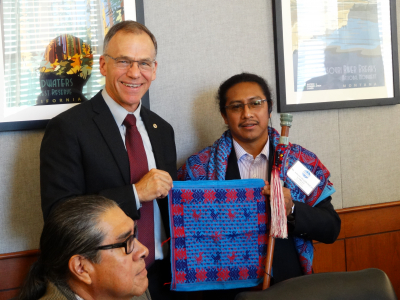 Alberto Marroquin Garcia presenting a gift at the Bureau of Land Management