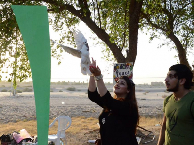 Woman releasing bird at the Free a Bird Booth