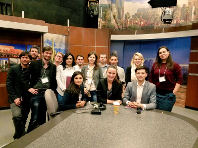 European Murrow group gathers behind the KPNX TV Phoenix News Desk during a station tour.