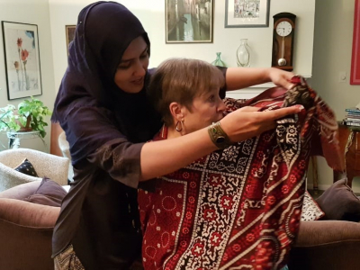 Presenting a traditional Pakistani shawl to home hospitality hosts in Pittsburgh