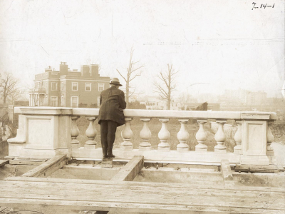 A man gazes out across 16th St. from Meridian Hill Park, then under construction. The park sits on land that was previously home to 40 families — all but one African American — who were displaced by development in the early 20th century.