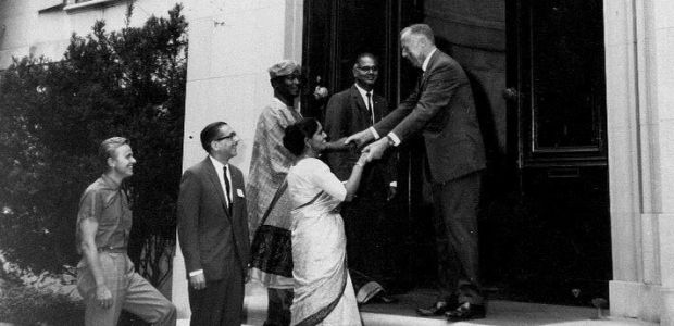 Mr. Andrew Harding of COSERV (now Global Ties US) greets international visitors in 1964 at Meridian House