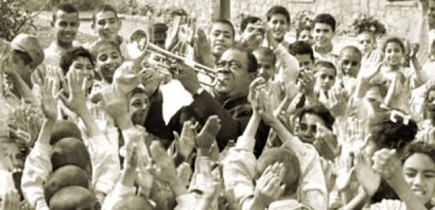 Louis Armstrong entertains children at the Tahhseen Al-Sahha Medical Center. Cairo, Egypt, 1961. Courtesy of the Louis Armstrong House Museum.