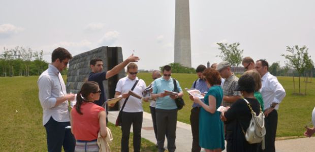 A representative from the National Capital Planning Commission explains the function of the levee on the Capital Mall to an IVLP Climate Change group.