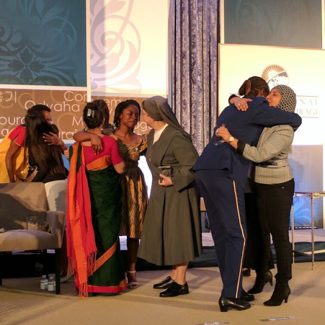 Awardees embrace one another at the ceremony