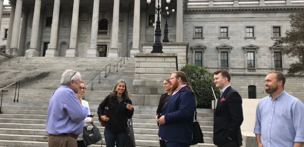 Swedish journalists and members of the Palmetto Council for International Visitors, Jim Byrum and Lisa Ewart, stand outside of the State House in Columbia, South Carolina while on a tour of the city.