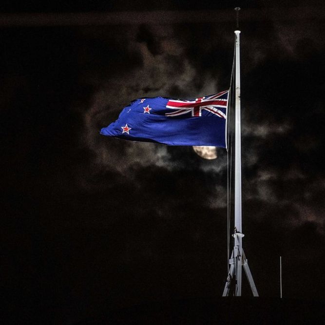 The national flag was flown at half-staff on Friday outside the Parliament building in Wellington.CreditMarty Melville/Agence France-Presse — Getty Images