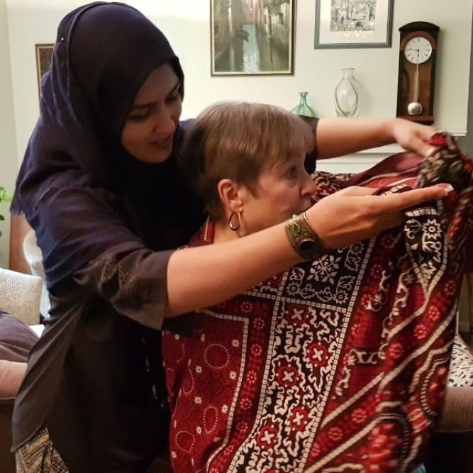 Presenting a traditional Pakistani shawl to home hospitality hosts in Pittsburgh