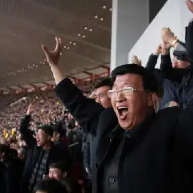 North Koreans cheer after their women’s soccer team scored their first goal against South Korea in a qualifying match for the Asian Football Confederation Cup at the Kim Il Sung Stadium on Friday, April 7, 2017, in Pyongyang, North Korea.