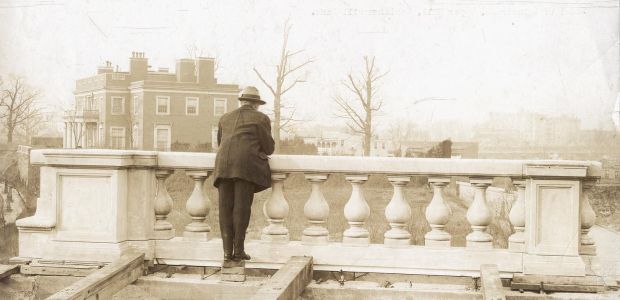 A man gazes out across 16th St. from Meridian Hill Park, then under construction. The park sits on land that was previously home to 40 families — all but one African American — who were displaced by development in the early 20th century.