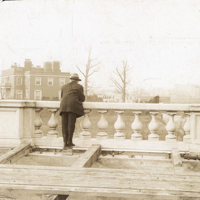 A man gazes out across 16th St. from Meridian Hill Park, then under construction. The park sits on land that was previously home to 40 families — all but one African American — who were displaced by development in the early 20th century.