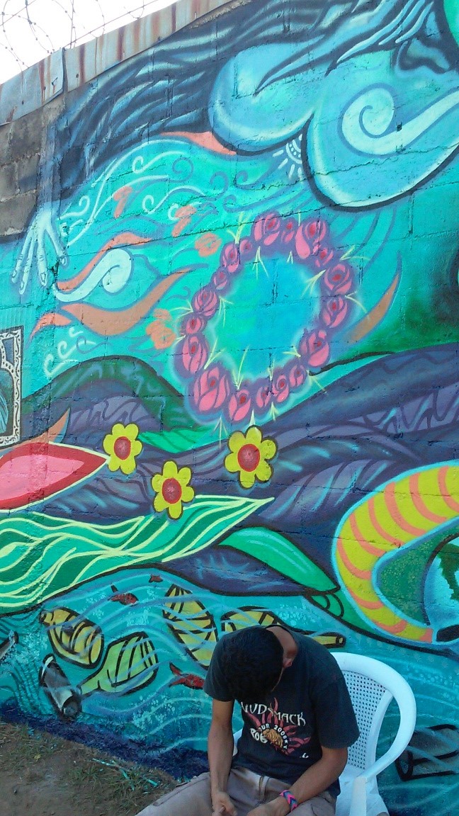 Mural themes include contamination of the river and natural resources.