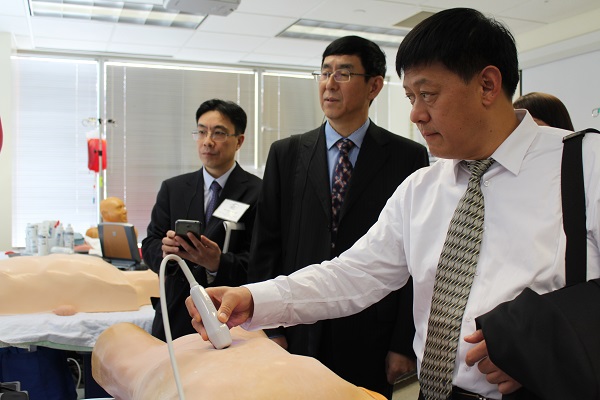 Delegates experiment with the simulation dummies while on their tour of the Peter M. Winter Institution for Simulation, Education, and Research (WISER). 